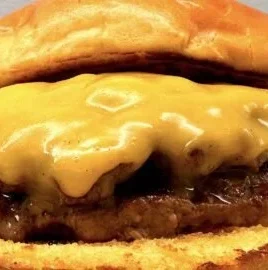 Delicious homemade smash burger served with toppings and fries