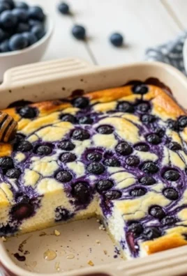 Blueberry Cottage Cheese Breakfast Bake in a baking dish with fresh blueberries on top.