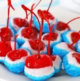 Colorful boozy cherry bombs cocktails with cherries and alcohol served in glasses.
