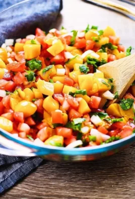 Freshly made chunky peach salsa served in a bowl.
