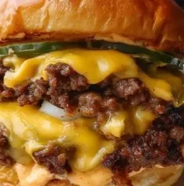 Crispy smash burger with lacy edges and secret sauce on a wooden plate