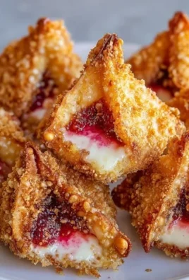Crispy wonton bites filled with deep-fried strawberry cheesecake.