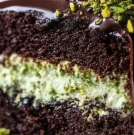 Delicious Dubai Chocolate Pistachio Cake topped with nuts and chocolate frosting