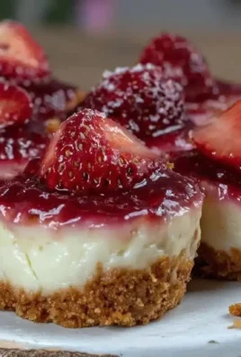 Mini no-bake strawberry cheesecake bites served on a colorful plate