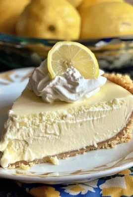 Deliciously refreshing Frozen Lemonade Pie topped with whipped cream and lemon slices.