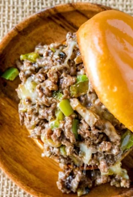 Gordon Ramsay's Philly Cheesesteak Sloppy Joes served on a plate with fresh toppings.