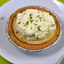 Delicious Greek Yogurt Key Lime Pie served with fresh lime and whipped cream