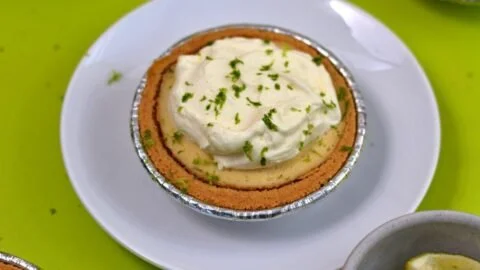Delicious Greek Yogurt Key Lime Pie served with fresh lime and whipped cream