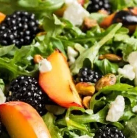 Delicious grilled peach salad with greens and toppings