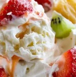 Delicious Hawaiian cheesecake salad garnished with fruit and creamy topping