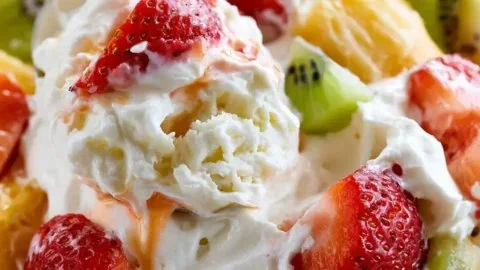 Delicious Hawaiian cheesecake salad garnished with fruit and creamy topping