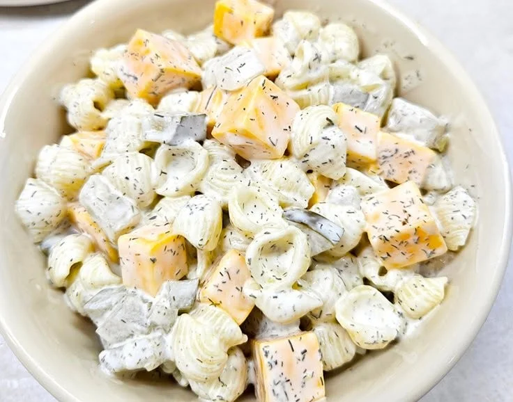 Bowl of homemade dill pickle pasta salad with fresh ingredients
