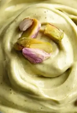 Jar of homemade pistachio cream on a wooden table