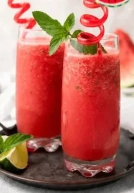 Refreshing homemade watermelon slushie served in a glass with ice