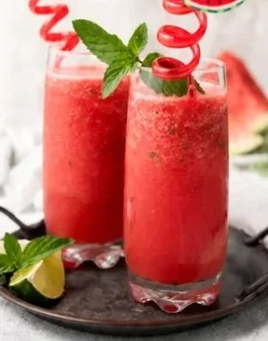 Refreshing homemade watermelon slushie served in a glass with ice