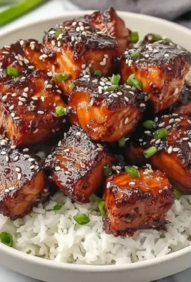 Honey Garlic Salmon Bites Bowl with garnishes served in a rustic bowl