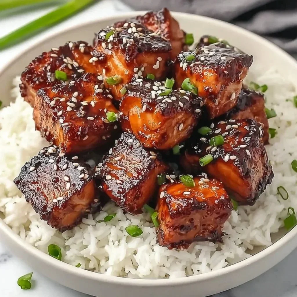 Honey Garlic Salmon Bites Bowl with garnishes served in a rustic bowl
