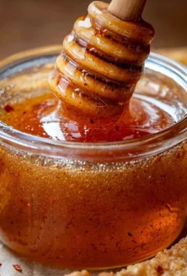 Jar of hot honey with chili peppers, perfect for adding spice to dishes