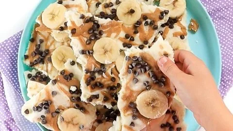 Kid-friendly frozen yogurt bark topped with peanut butter and bananas