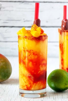 Chilled mango slushie in a glass with fresh mango slices