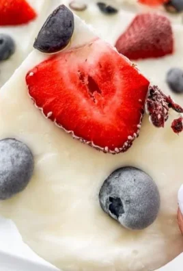 Healthy mixed berry yogurt bark topped with fresh berries and yogurt
