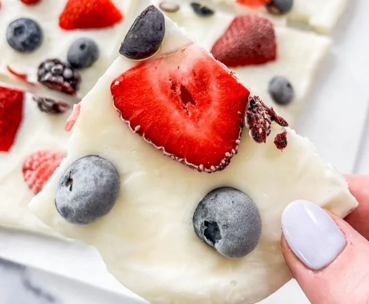 Healthy mixed berry yogurt bark topped with fresh berries and yogurt