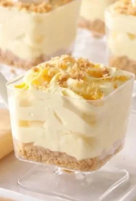 No-Bake Lemon Cheesecake Mousse Cups topped with lemon zest