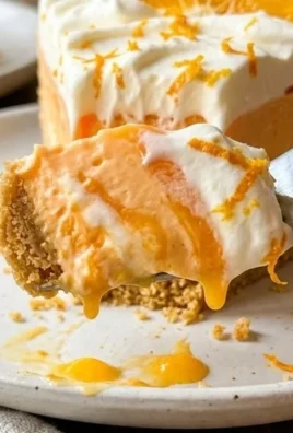 No-Bake Orange Cheesecake with a creamy orange topping on a graham cracker crust.