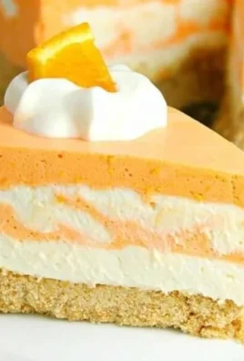 No-Bake Orange Creamsicle Cheesecake served on a plate with orange slices