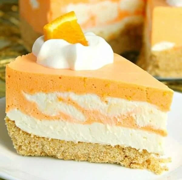 No-Bake Orange Creamsicle Cheesecake served on a plate with orange slices