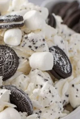 Delicious Oreo Fluff Delight dessert served in a bowl with crushed Oreos.