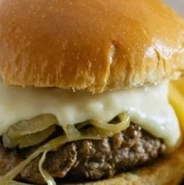 Delicious Philly Burger served with fresh toppings and a side of fries