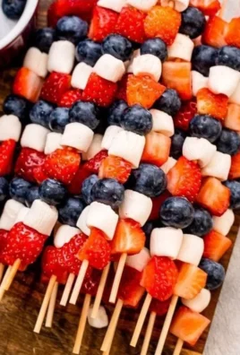 Red, White, and Blue fruit kabobs made with strawberries, blueberries, and marshmallows.