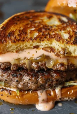 Delicious smashed patty burger topped with secret sauce on a plate