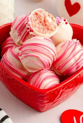 Homemade strawberry cheesecake balls topped with fresh strawberries