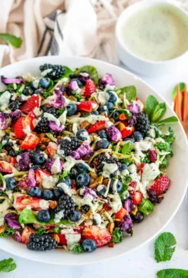 Superfood berry salad with creamy lemon herb dressing on a plate.