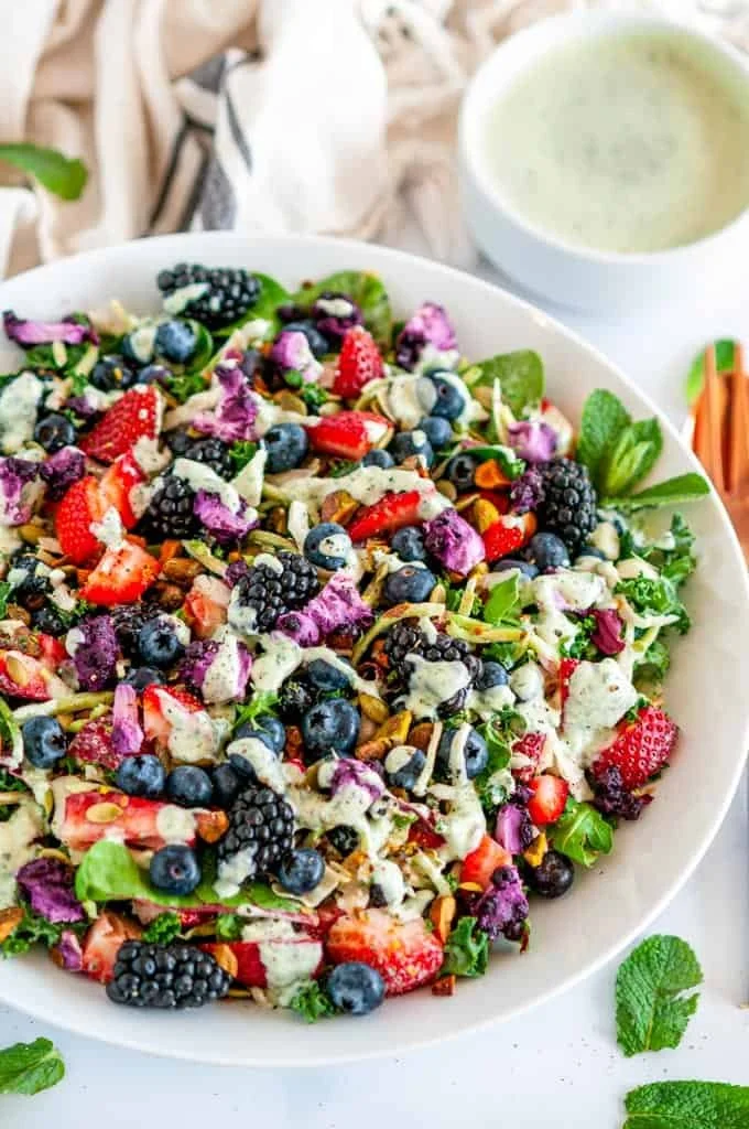 Superfood berry salad with creamy lemon herb dressing on a plate.