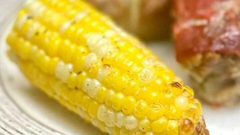 Delicious air fryer corn on the cob served with butter and herbs.
