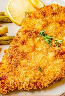 Crispy air fryer fried chicken garnished with herbs and served on a plate