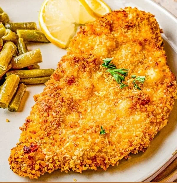 Crispy air fryer fried chicken garnished with herbs and served on a plate