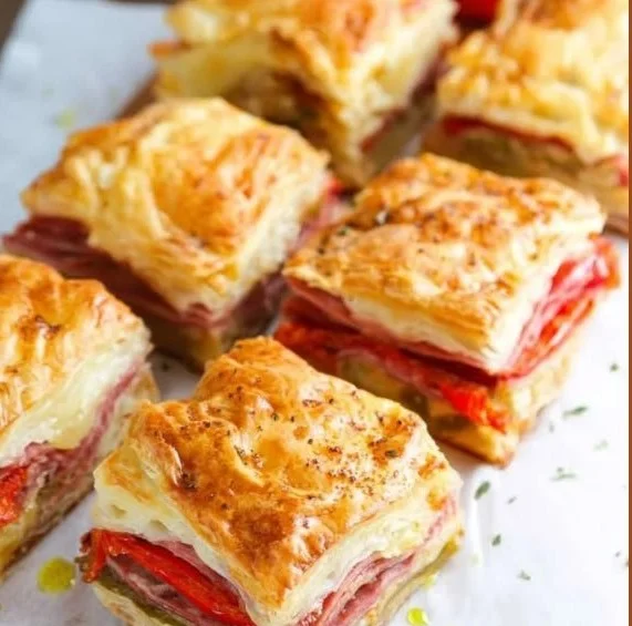 Plate of colorful antipasto squares with assorted meats, cheeses, and vegetables