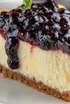 Delicious blueberry cheesecake topped with fresh blueberries and whipped cream.