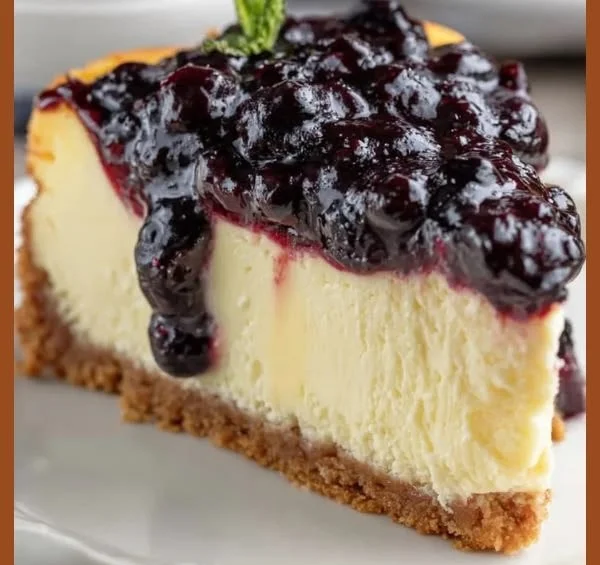 Delicious blueberry cheesecake topped with fresh blueberries and whipped cream.