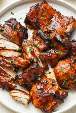 Oven-cooked caramelized BBQ chicken thighs served on a plate