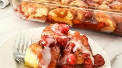 Delicious cherry pie bubble up dessert served in a dish with a scoop of ice cream