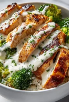 Chicken and broccoli bowls with creamy garlic sauce for a healthy meal.