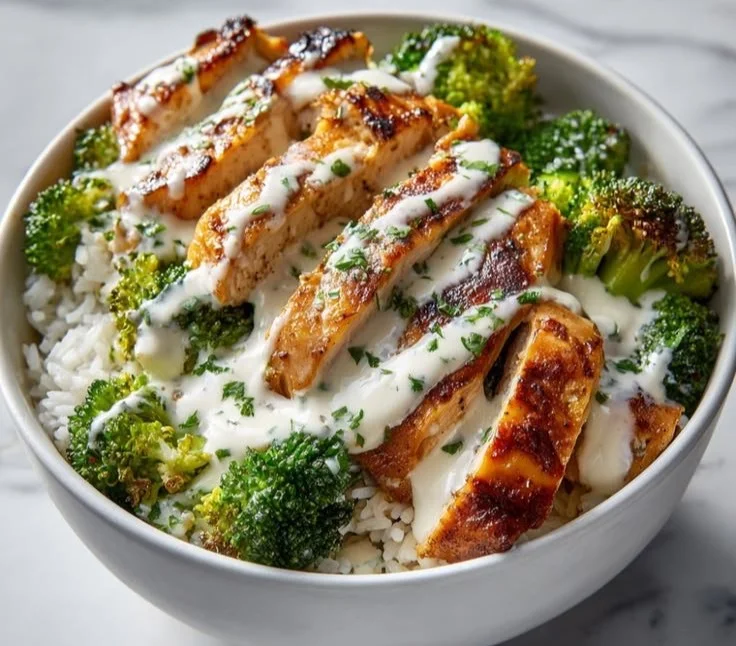 Chicken and broccoli bowls with creamy garlic sauce for a healthy meal.