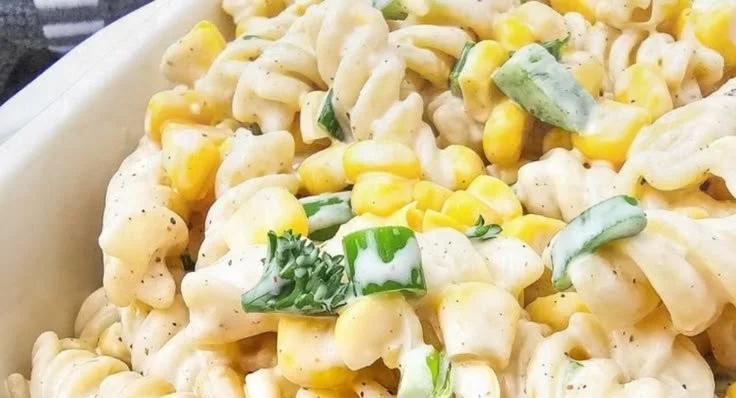 Delicious corn on the cob pasta salad served in a vibrant bowl.