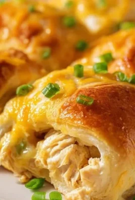 Crescent chicken roll-ups served on a plate with fresh herbs