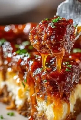 Delicious deep hamburger pie topped with sausage and pepperoni, served on a plate.